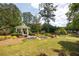 Idyllic gazebo on lush green lawn surrounded by colorful landscaped beds overlooking the pond at 139 Lake Reserve Way, Canton, GA 30115