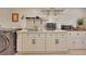 The kitchen area features white cabinets, appliances, a sink, and stylish fixtures at 139 Lake Reserve Way, Canton, GA 30115