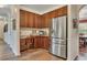 Gourmet kitchen featuring stainless steel refrigerator and custom wood cabinets at 139 Lake Reserve Way, Canton, GA 30115