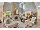 Open-concept living room with stone fireplace, high ceilings, and wood floors at 139 Lake Reserve Way, Canton, GA 30115