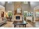 Great room with a stone fireplace, wood floors, and high ceilings at 139 Lake Reserve Way, Canton, GA 30115