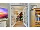 Elegant living room featuring a grand piano and chandelier seen through open French doors at 139 Lake Reserve Way, Canton, GA 30115