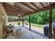 Wide covered patio with grill, seating and view of landscaped backyard at 139 Lake Reserve Way, Canton, GA 30115
