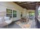 A screened porch with cozy seating and wood floors at 139 Lake Reserve Way, Canton, GA 30115