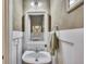 Stylish powder room with decorative mirror, beadboard, and neutral wall color at 139 Lake Reserve Way, Canton, GA 30115