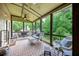 Relaxing screened porch featuring ceiling fan, comfortable seating, and peaceful outdoor view at 139 Lake Reserve Way, Canton, GA 30115