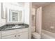 Updated bathroom with new mirror, vanity, granite top and shower-tub combination at 1445 Monroe Ne Dr # F18, Atlanta, GA 30324