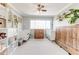 Bright bedroom with two cribs, wooden storage, ceiling fan, and natural light at 1445 Monroe Ne Dr # F18, Atlanta, GA 30324