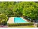 Community pool surrounded by lush greenery and lounge chairs, ideal for summer relaxation at 1445 Monroe Ne Dr # F18, Atlanta, GA 30324