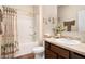 This bathroom features a vanity with drawers and a cabinet, along with a toilet, bathtub, and shower at 1907 Sea Oats Dr, Hampton, GA 30228