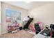 This room features a window that lets in natural light, along with a desk and exercise machine at 1907 Sea Oats Dr, Hampton, GA 30228