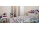 This bedroom has a floral comforter and a vanity table with plenty of space for displaying personal items at 1907 Sea Oats Dr, Hampton, GA 30228