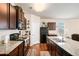 Well-equipped kitchen showcases granite countertops, stainless steel appliances, and dark wood cabinetry at 1907 Sea Oats Dr, Hampton, GA 30228