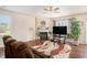 Bright living room with a fireplace, stylish decor, hardwood floors, and large windows with natural light at 1907 Sea Oats Dr, Hampton, GA 30228