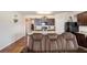 Open-concept living area showcasing kitchen with granite countertops, modern appliances, dark wood cabinets and living room furniture at 1907 Sea Oats Dr, Hampton, GA 30228