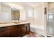 Bright main bathroom features double vanity, soaking tub, and tiled shower with glass door at 1907 Sea Oats Dr, Hampton, GA 30228