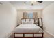 Cozy main bedroom featuring a ceiling fan, large bed, and natural lighting at 1907 Sea Oats Dr, Hampton, GA 30228