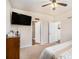 The main bedroom with a ceiling fan, mounted tv, and access to the main bathroom at 1907 Sea Oats Dr, Hampton, GA 30228