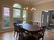 Formal dining room with large windows, chandelier, and classic dining set perfect for Gathering gatherings at 5440 Cameron Forest Pkwy, Johns Creek, GA 30022