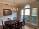 Elegant dining room with classic decor, large window offering natural light, and stylish chandelier at 5440 Cameron Forest Pkwy, Johns Creek, GA 30022