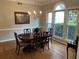 Inviting dining room features natural light, classic furnishings, and hardwood floors at 5440 Cameron Forest Pkwy, Johns Creek, GA 30022