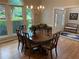 Elegant dining room with large windows, chandelier, and formal dining table with chairs at 5440 Cameron Forest Pkwy, Johns Creek, GA 30022