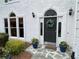 Charming front door with decorative wreath and potted plants enhancing curb appeal at 5440 Cameron Forest Pkwy, Johns Creek, GA 30022