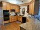 Well-equipped kitchen with granite counters, modern appliances, hardwood floors, and a stylish tile backsplash at 5440 Cameron Forest Pkwy, Johns Creek, GA 30022