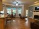 Open concept living room with hardwood floors, fireplace, and large windows flowing into a breakfast nook at 5440 Cameron Forest Pkwy, Johns Creek, GA 30022