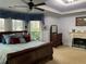 Spacious main bedroom with a fireplace, carpet, tray ceilings and large windows at 5440 Cameron Forest Pkwy, Johns Creek, GA 30022