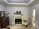 Bright bedroom with fireplace, carpet, and an open doorway to bathroom at 5440 Cameron Forest Pkwy, Johns Creek, GA 30022