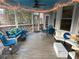 Relaxing screened-in patio with comfortable seating, string lights, and ceiling fan for outdoor enjoyment at 5440 Cameron Forest Pkwy, Johns Creek, GA 30022
