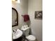 Powder room featuring a pedestal sink, toilet, framed art, and neutral paint at 5440 Cameron Forest Pkwy, Johns Creek, GA 30022