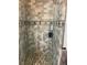 Tiled shower with glass door and stone flooring at 5440 Cameron Forest Pkwy, Johns Creek, GA 30022