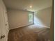 Bedroom features carpet, a window providing natural light, and a door to the rest of the home at 55 Barton Ln, Covington, GA 30016
