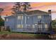 Large backyard featuring a trampoline and entertainment area with a gray deck at 771 James Cir, Lawrenceville, GA 30046