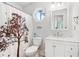 Well-lit bathroom with a vanity and decorative shower curtain and octagon window at 771 James Cir, Lawrenceville, GA 30046