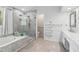 Renovated bathroom showcasing a glass shower, soaking tub, and modern fixtures at 771 James Cir, Lawrenceville, GA 30046
