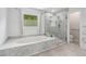 Updated bathroom with a soaking tub, separate glass shower, and a window at 771 James Cir, Lawrenceville, GA 30046