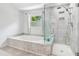 Updated bathroom with a soaking tub, separate glass shower, and a window at 771 James Cir, Lawrenceville, GA 30046
