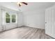 A sunny bedroom has beautiful flooring, an open door and bright window at 771 James Cir, Lawrenceville, GA 30046