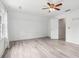 A spacious room with natural light, laminate flooring, and a ceiling fan at 771 James Cir, Lawrenceville, GA 30046