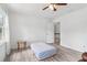 A light-filled bedroom with wood-look flooring, table, and access to the landing at 771 James Cir, Lawrenceville, GA 30046