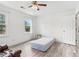 Bright bedroom features wood-look flooring, ceiling fan, and a pair of windows at 771 James Cir, Lawrenceville, GA 30046