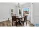 Bright dining room features a wood table, chandelier, and large windows offering ample natural light at 771 James Cir, Lawrenceville, GA 30046