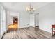 Light-filled dining room with molding detail, hardwood floors, and modern chandelier at 771 James Cir, Lawrenceville, GA 30046