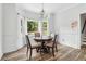 Cozy dining room features a wood table, chandelier, and large windows offering ample natural light at 771 James Cir, Lawrenceville, GA 30046