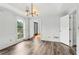 Elegant dining area with hardwood floors, wainscoting, and natural light at 771 James Cir, Lawrenceville, GA 30046