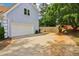 A home showing the driveway, white garage door and partial view of a fenced backyard at 771 James Cir, Lawrenceville, GA 30046
