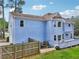 A home's blue exterior with a well-manicured lawn and fenced in backyard at 771 James Cir, Lawrenceville, GA 30046